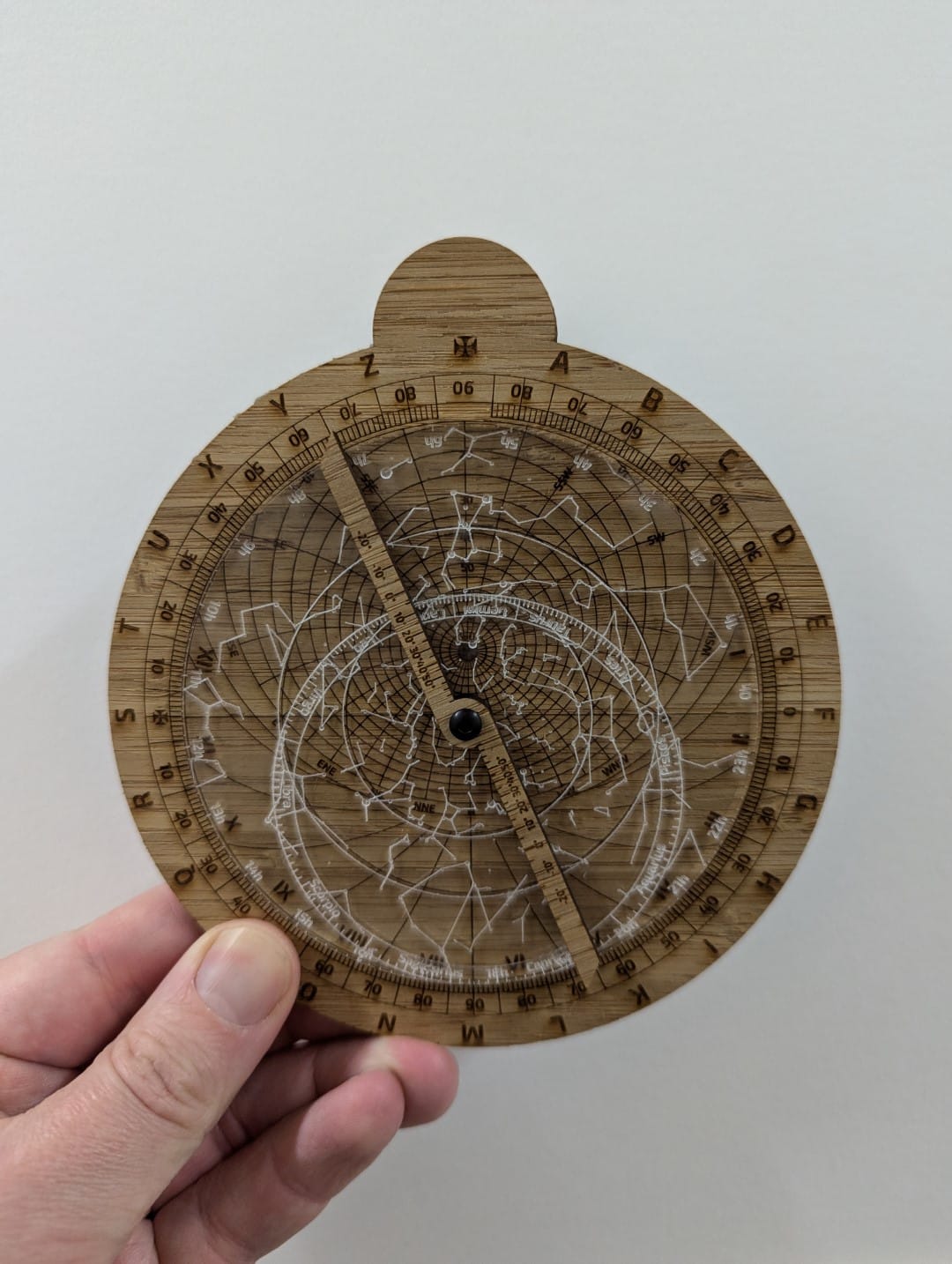 Wooden astrolabe, laser etched, with a clear plastic acrylic rete.